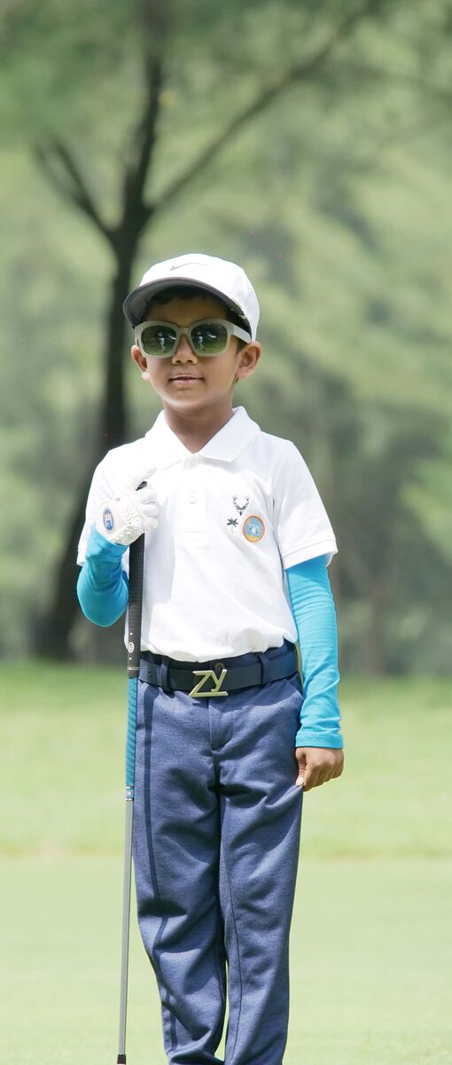 Shinav posing with club on course